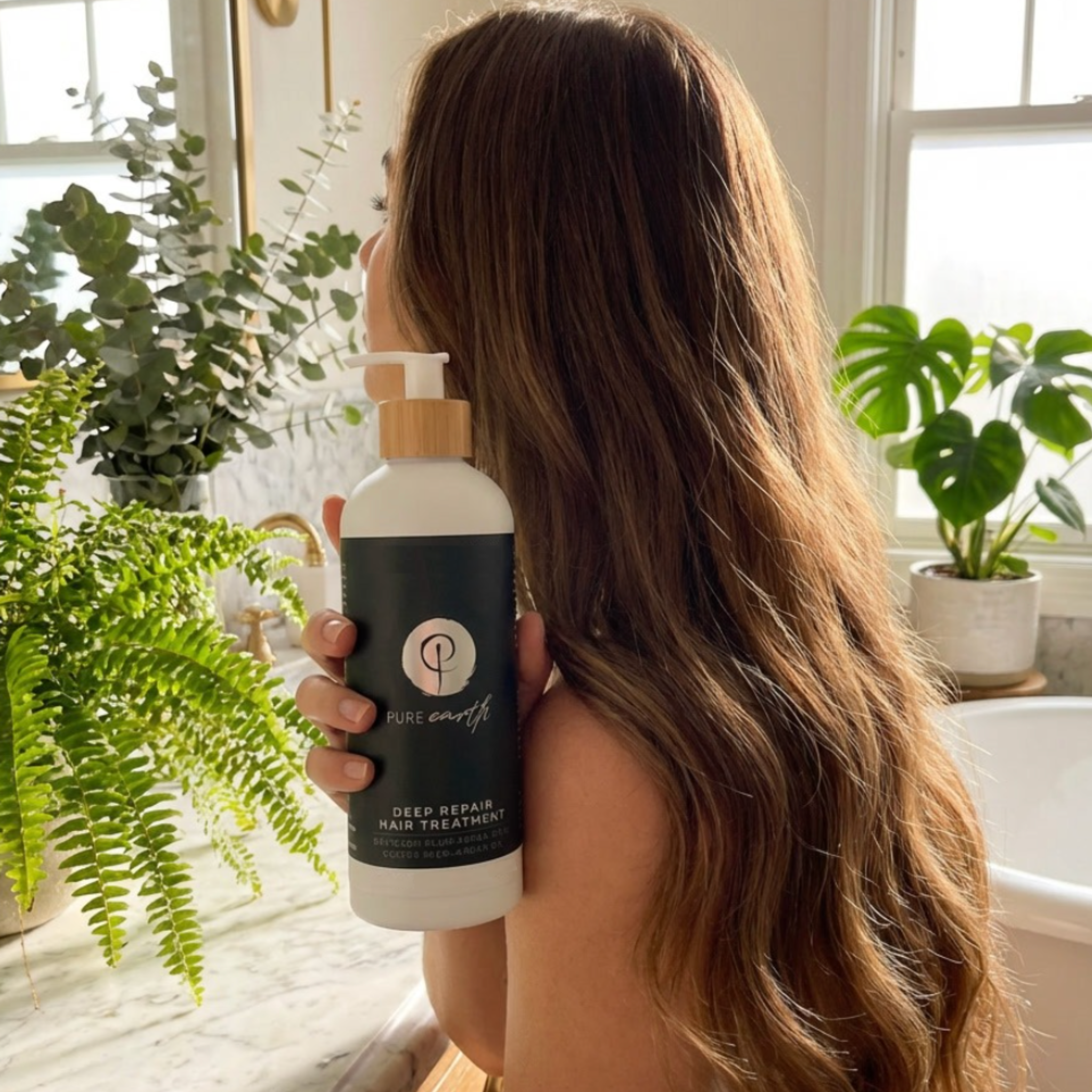 Lady with long healthy hair holding Pure Earth Deep Repair Hair Treatement in bathroom with plants and natural lighting