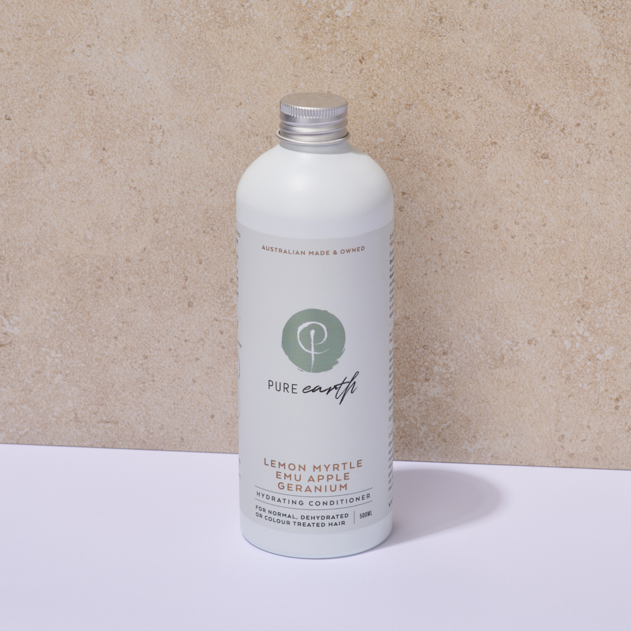 White bottle of Pure Earth hydrating conditioner on a beige background with natural bamboo pump