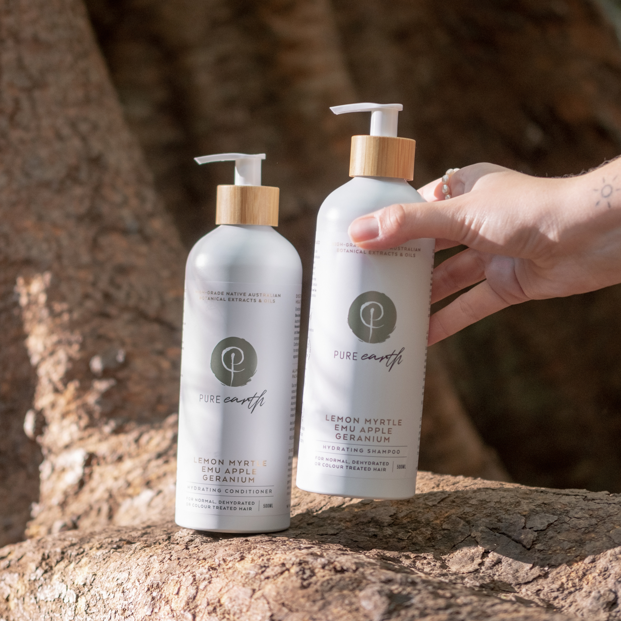 Person grabbing Pure Earth natural hydrating shampoo and conditioner in plastic free packaging