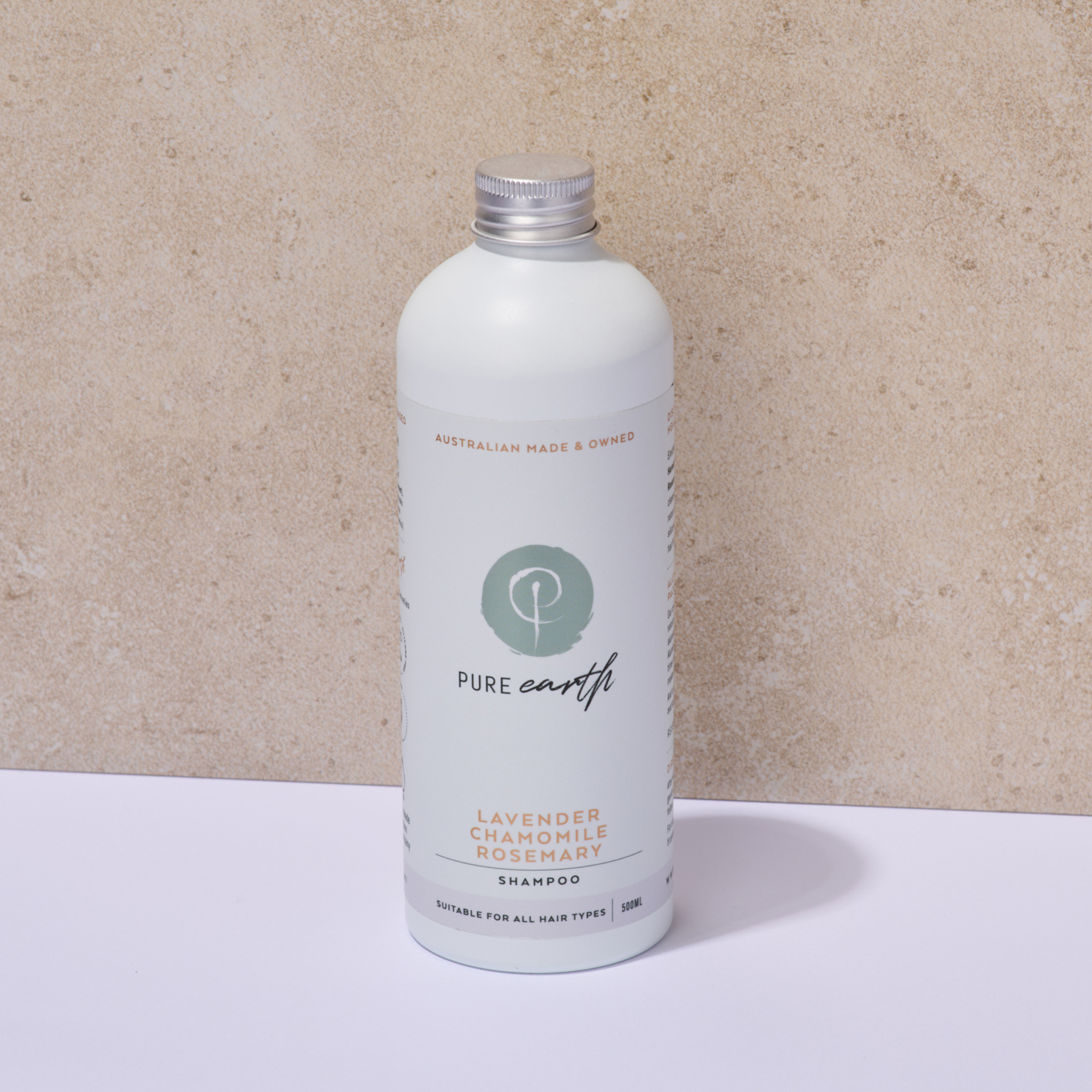 White bottle of Pure Earth natural shampoo with plastic-free aluminium cap