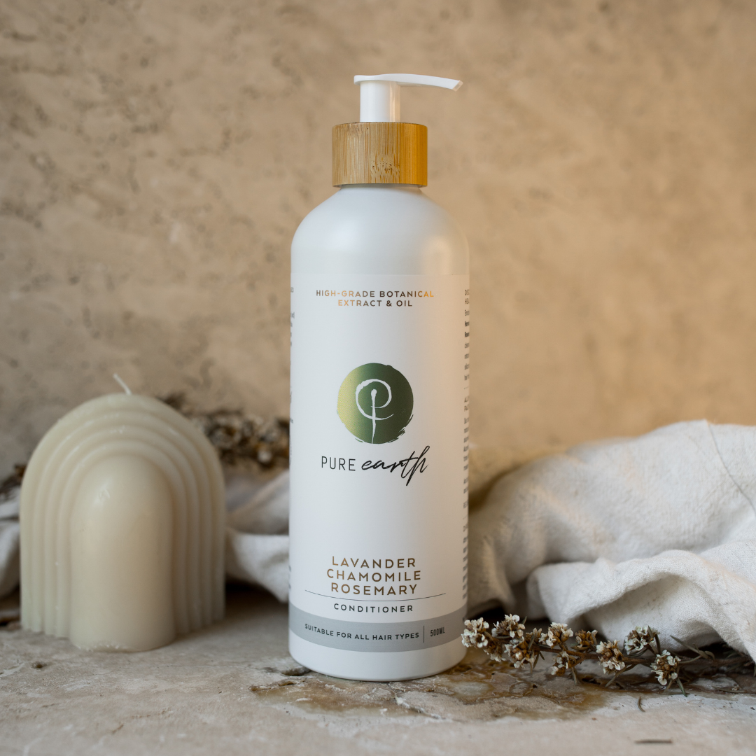 A bottle of natural conditioner with a pump dispenser, labeled &