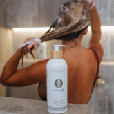 Person washing with Pure Earth natural shampoo with lavender chamomile and rosemary by Pure Earth – gentle botanical hair care for soft healthy hair