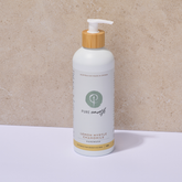 Bottle of Pure Earth lemon myrtle chamomile handwash with a wooden pump on a beige background