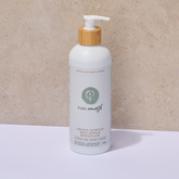 White Pure Earth Hydrating Conditioner bottle with a wooden pump on a beige background