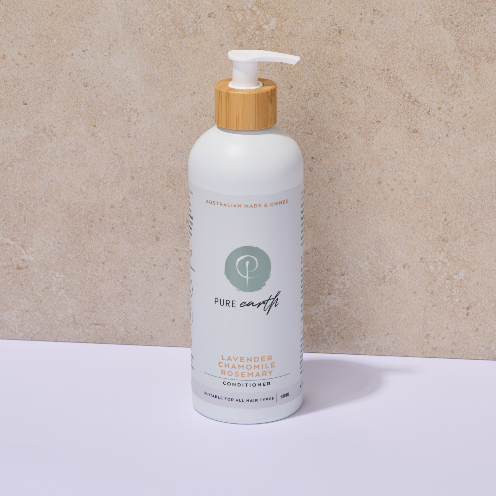 White Pure Earth bottle with pump and wooden cap on a beige background