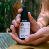 Pure Earth Kakadu Plum Facial Oil dropper bottle natural face oil for hydration glowing skin and barrier support held in hand
