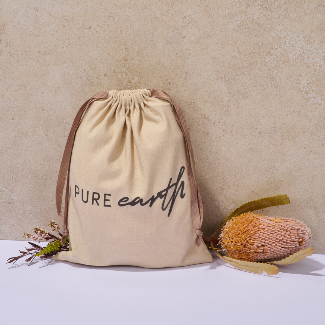 Pure Earth reusable natural linen gift bag with drawstring closure and Pure Earth logo, designed for sustainable Christmas gifting.