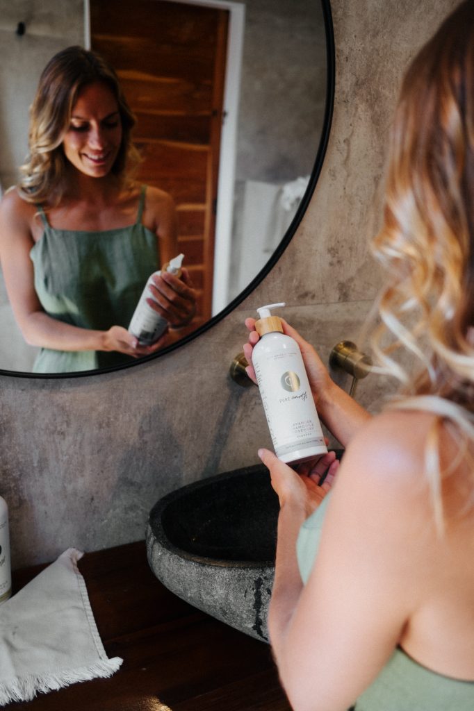 Woman Holding Pure Earth Natural Skincare Shampoo